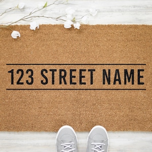 May include: A brown coir doormat with the text "123 STREET NAME" printed in black.
