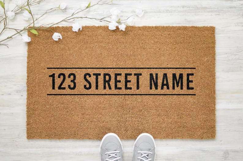 May include: A brown coir doormat with the text "123 STREET NAME" printed in black.