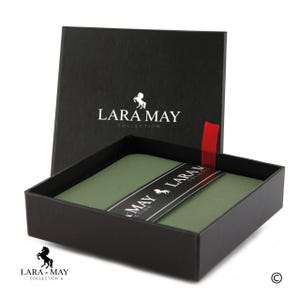 May include: A green leatherette gift box with a black label that reads "Lara May Collection". The box is closed and has a black horse logo on the front.