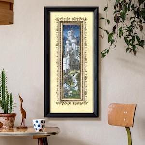 May include: A framed print of a medieval-style illustration depicting a white castle with a forest and a waterfall. The print is surrounded by a gold ornate frame.