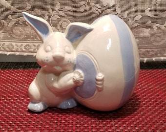 White Ceramic Bunny holding a White and Blue Easter Egg Figurine
