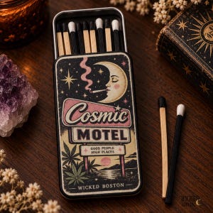 May include: A rectangular metal matchbox featuring a graphic of a crescent moon smoking, with the text Cosmic Motel, Good People High Places, and Wicked Boston. The box contains wooden matches with black and white tips, with two loose matches nearby.