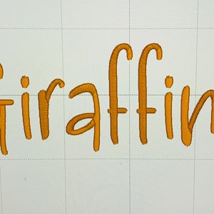 May include: A gold embroidered word "Giraffing" on a white background.
