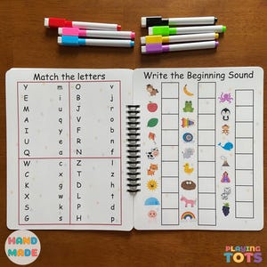 May include: A handmade educational activity book with spiral binding, featuring letter matching and beginning sound exercises. Includes colorful dry-erase markers in various colors. The book has the text "Match the letters" and "Write the Beginning Sound".