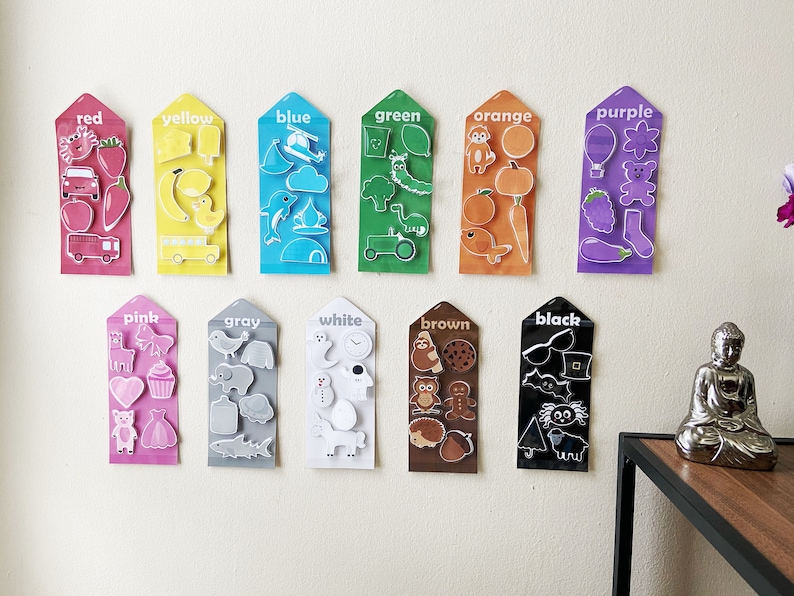 May include: A set of 12 color cards with various images on each card. The cards are labeled with the color name: red, yellow, blue, green, orange, purple, pink, gray, white, brown, black. Each card has a different color background and features various images related to that color.