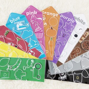 May include: A colorful fan-shaped learning tool with different colored cards featuring various images and the word for each color. The colors include red, yellow, green, blue, pink, orange, purple, white, brown, gray, and black.