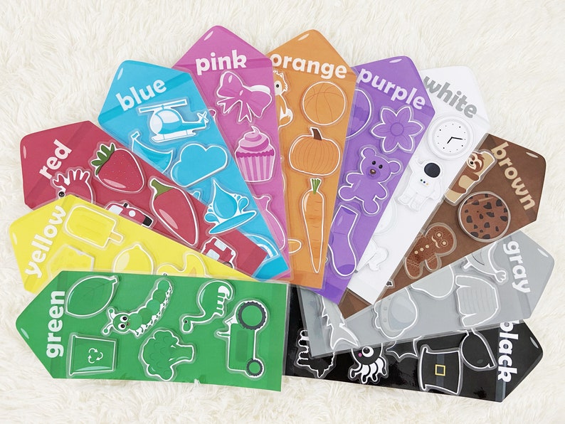 May include: A colorful fan-shaped learning tool with different colored cards featuring various images and the word for each color. The colors include red, yellow, green, blue, pink, orange, purple, white, brown, gray, and black.