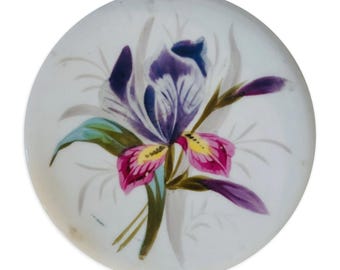 Preciosa alfombrilla de ratón redonda con el diseño de una flor de iris morada.