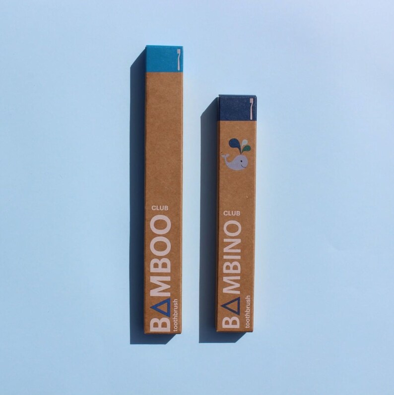 May include: Two cardboard boxes with blue accents, one labeled "CLUB BAMBOO toothbrush" and the other labeled "CLUB BAMBINIO toothbrush".