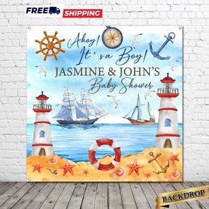 May include: A nautical themed baby shower backdrop with a blue and white watercolor background. The backdrop features two lighthouses, a sailboat, a compass, a life preserver, and the text "Ahoy! It's a Boy! Jasmine & John's Baby Shower".