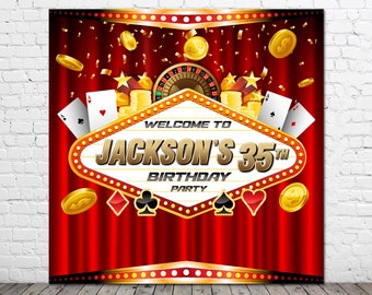 May include: A red and gold casino-themed backdrop with a Las Vegas sign that says "Welcome to Jackson's 35th Birthday Party". The backdrop features playing cards, gold coins, and a roulette wheel.