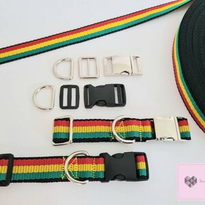 May include: A set of red, yellow, and green striped webbing for making a dog collar or leash. The set includes two metal D-rings, two metal slide buckles, one black plastic buckle, and one black plastic slide buckle. The webbing is 25mm wide.