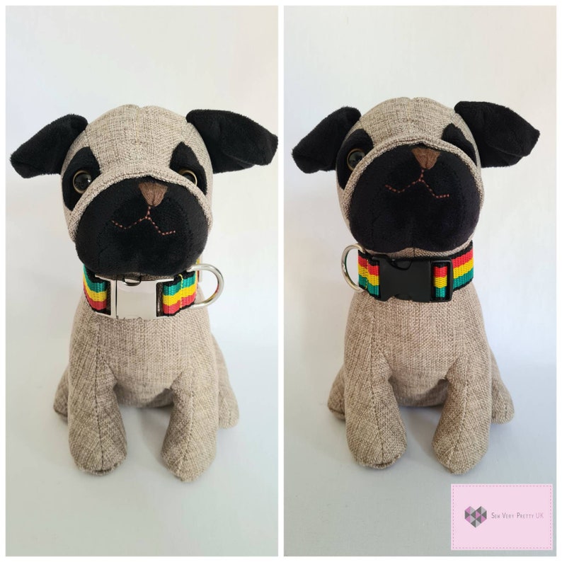 May include: A plush grey and black pug dog toy with a red, yellow, and green striped collar. The collar has a silver buckle.