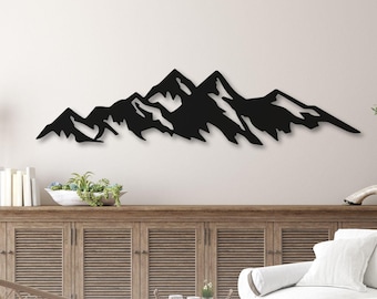 May include: A black metal mountain range wall art piece. The artwork is crafted from birch wood and handmade in the USA. The image also includes the text "30 DAY GUARANTEE".