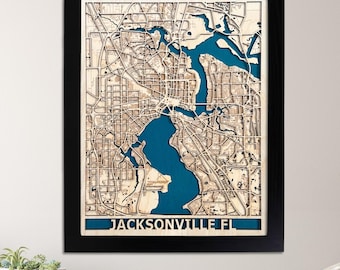 May include: A framed wooden map of Jacksonville, Florida, with a blue water feature. The map is made of natural birch wood and is handmade in the USA. The image also shows a quality guarantee icon.