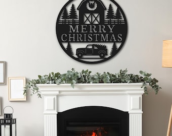 May include: Black metal Christmas sign with a barn, trees, and a truck carrying a Christmas tree. The sign reads "MERRY CHRISTMAS" in a circular design. The sign is hanging above a white fireplace with a burning fire.
