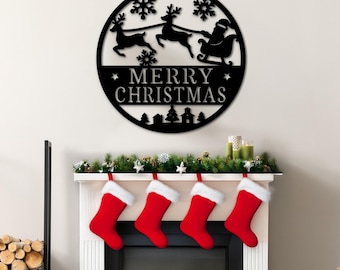 May include: Black metal Christmas sign featuring Santa Claus in a sleigh pulled by reindeer, snowflakes, and the words "MERRY CHRISTMAS." The sign is above a fireplace decorated with stockings and greenery, creating a festive holiday scene.