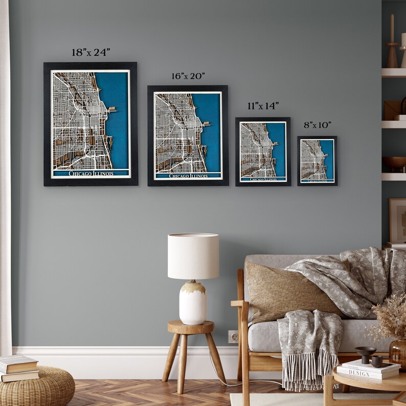 May include: Four framed wooden map art pieces of Chicago, Illinois, in varying sizes: 45.7cm x 61cm, 40.6cm x 50.8cm, 28cm x 35.6cm, and 20.3cm x 25.4cm. Each map features a detailed city layout with a blue background and white border.