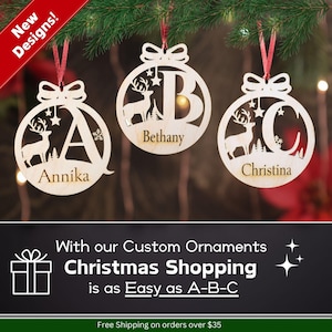 May include: Three wooden Christmas ornaments with a deer and a letter cut out in the center. The ornaments are personalized with the names Annika, Bethany, and Christina.