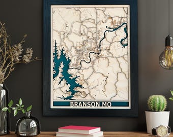 May include: A wooden 3D map of Branson, Missouri, in a dark blue frame. The map features a blue lake and brown land. The text "BRANSON MO" is printed on the bottom of the map.