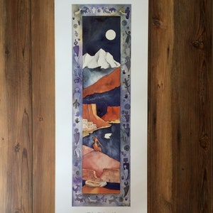 May include: A watercolor painting of a Native American flute player in a desert landscape. The painting is framed with a border of Native American symbols. The title of the painting is "Kokopelli's Serenade" by Kathy Conway.