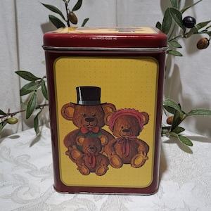 May include: A vintage red and yellow tin with a design of three teddy bears. The bears are brown and have a yellow background with white polka dots. The text on the tin reads "© 1994 PARCO FOODS, INC."