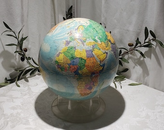 May include: A blue globe with a colorful map of the world on it. The globe is on a clear plastic stand.
