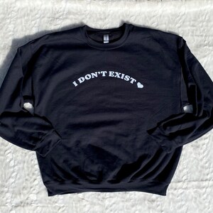 May include: Black sweatshirt with white text that reads "I DON'T EXIST" with a small heart symbol.