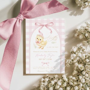 May include: A baby shower invitation with a pink gingham background and a watercolor illustration of a chick wearing a floral crown. The text reads "A Little Chick is on the Way" and includes event details.