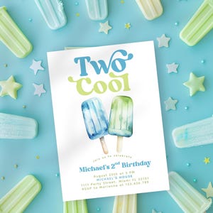 May include: A birthday invitation with the text "Two Cool" and watercolor popsicle illustrations. The invitation is surrounded by popsicle-shaped candies and star-shaped decorations on a light blue background.
