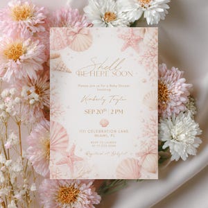 May include: A baby shower invitation with a seashell theme. The invitation features the text "Shell Be Here Soon" and details for Kimberly Taylor's baby shower, including the date, time, and location. The design includes seashells, starfish, and floral accents.