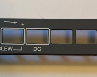 May include: A gray panel with six rectangular openings and white text that reads "DG Slew", "DG", "ATT/HDG", and "ALIGN".