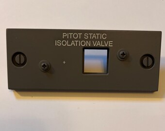 May include: A gray metal panel with the text "PITOT STATIC ISOLATION VALVE" and a small rectangular window.