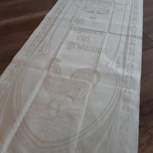 unused linen towel, Art Nouveau style, sun/rooster with saying