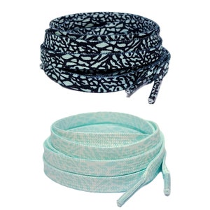 May include: Two pairs of shoelaces, one pair is black with a light blue pattern and the other pair is light blue with a white pattern.