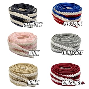 May include: Six pairs of braided shoelaces in various colors, including deep grey, red and blue, pink, light grey, khaki, and burgundy. Each pair features a white braided stripe.