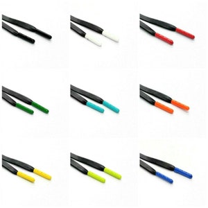 May include: Nine pairs of black shoelaces with different colored tips. The tips are white, red, orange, green, turquoise, yellow, lime green, and blue.