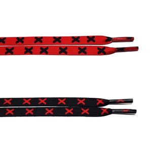 May include: Two pairs of shoelaces with a red and black criss-cross pattern. One pair is red with black crosses, and the other pair is black with red crosses.