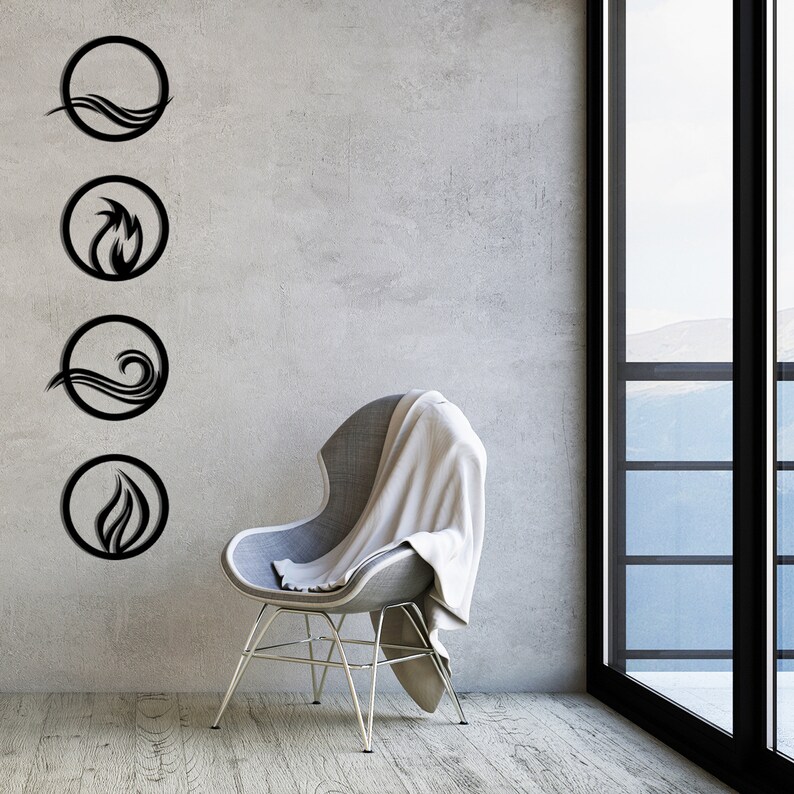 May include: Four black metal wall art pieces depicting the elements: water, fire, air, and earth. Each element is represented within a circular frame. The art is mounted on a textured gray wall, with a modern chair and window in the background.