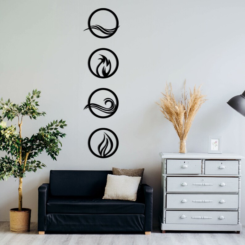 May include: Four black metal wall art pieces depicting the elements: water, fire, and air. Each element is represented within a circular frame. The art is mounted on a light gray wall, with a black sofa and a gray dresser in the background.