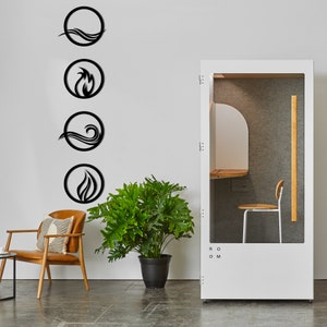 May include: Black metal wall art featuring four elemental symbols: water, fire, and air. The symbols are enclosed in circular frames. The image also shows a white soundproof booth with a chair, a potted plant, and a leather chair.