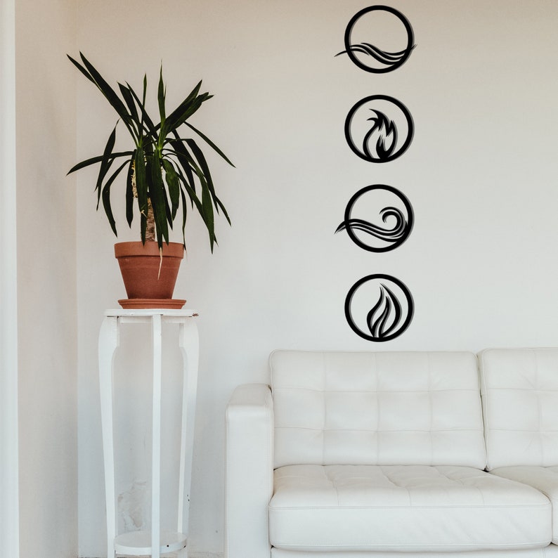 May include: Black metal wall art featuring four elemental symbols: water, fire, and air. Each symbol is enclosed in a circular frame. The art is displayed on a white wall above a white sofa. A potted plant sits on a white stand.