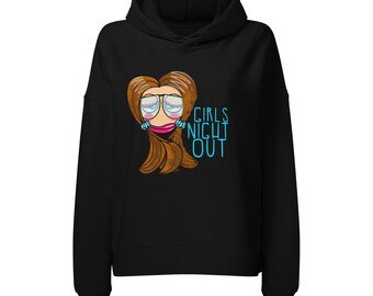Può includere: Una felpa con cappuccio nera caratterizzata da un'illustrazione grafica di un personaggio dei cartoni animati con capelli castani, occhiali e labbra rosa, posizionata sopra la scritta GIRLS NIGHT OUT in azzurro sul davanti.