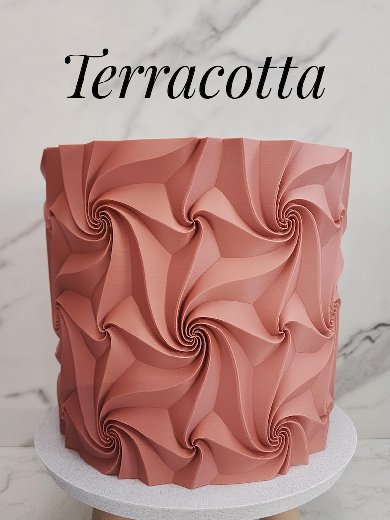 May include: A cylindrical terracotta-colored object featuring a repeating geometric pattern of swirling, raised ridges that create a vortex-like effect across the surface. The word Terracotta is printed in black text above the object.