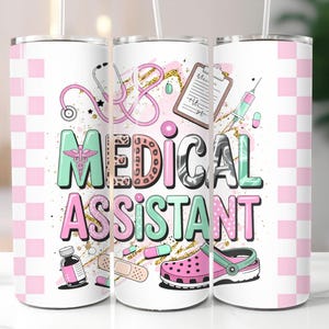 May include: A white tumbler featuring a pink and white chequered pattern and the words "MEDICAL ASSISTANT" in a colourful design. The design includes medical illustrations like a stethoscope and a pink shoe.