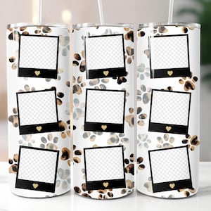 May include: Three white stainless steel tumblers with a paw print and photo frame design. Each tumbler features a repeating pattern of brown and tan paw prints and black photo frames with gold hearts.