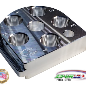 May include: A silver metal tool with six threaded holes, numbered 1 through 6. The tool is made in the USA with pride, as indicated by the label on the bottom. The tool is labeled "JOF-ER-USA -PRECISION-".
