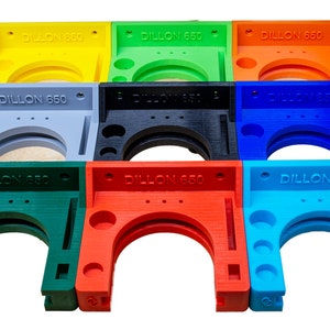 May include: Nine 3D printed wall mounts for a Dillon 650 reloading press. The mounts are in various colors: yellow, green, orange, gray, black, blue, green, red, and light blue.