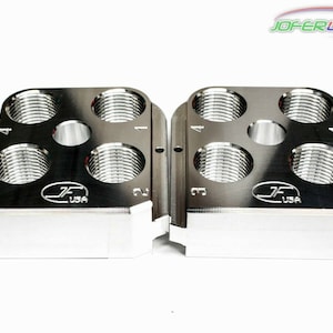 May include: Two silver metal gauge blocks with numbered holes for measuring threads. The blocks are labeled "JF USA".