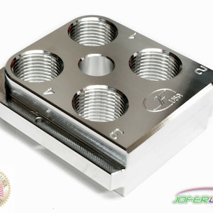 May include: A silver metal reloading block with four threaded holes and a center hole. The block is labeled "JOFER USA" and "CU".